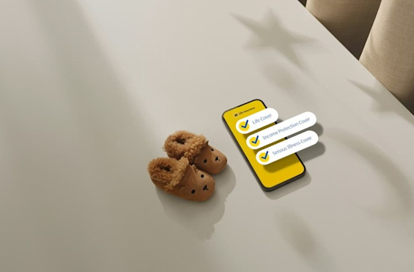 Smartphone displaying insurance checklist with "Life Cover", "Income Protection Cover", and "Serious Illness Cover" next to teddy bear slippers.